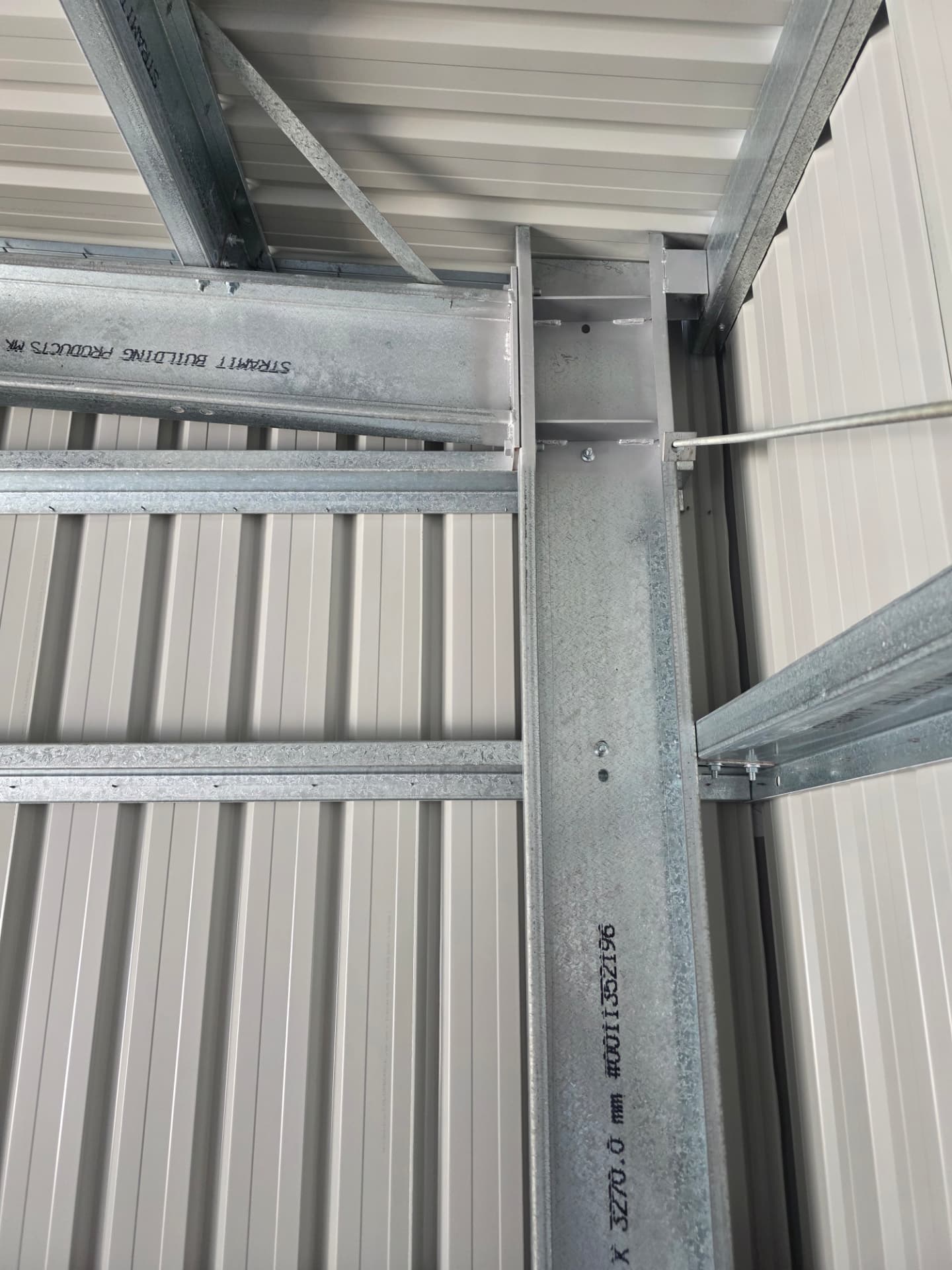 Welded steel knee plate and bolted portal frame connection inside a Spartan Sheds™ shed