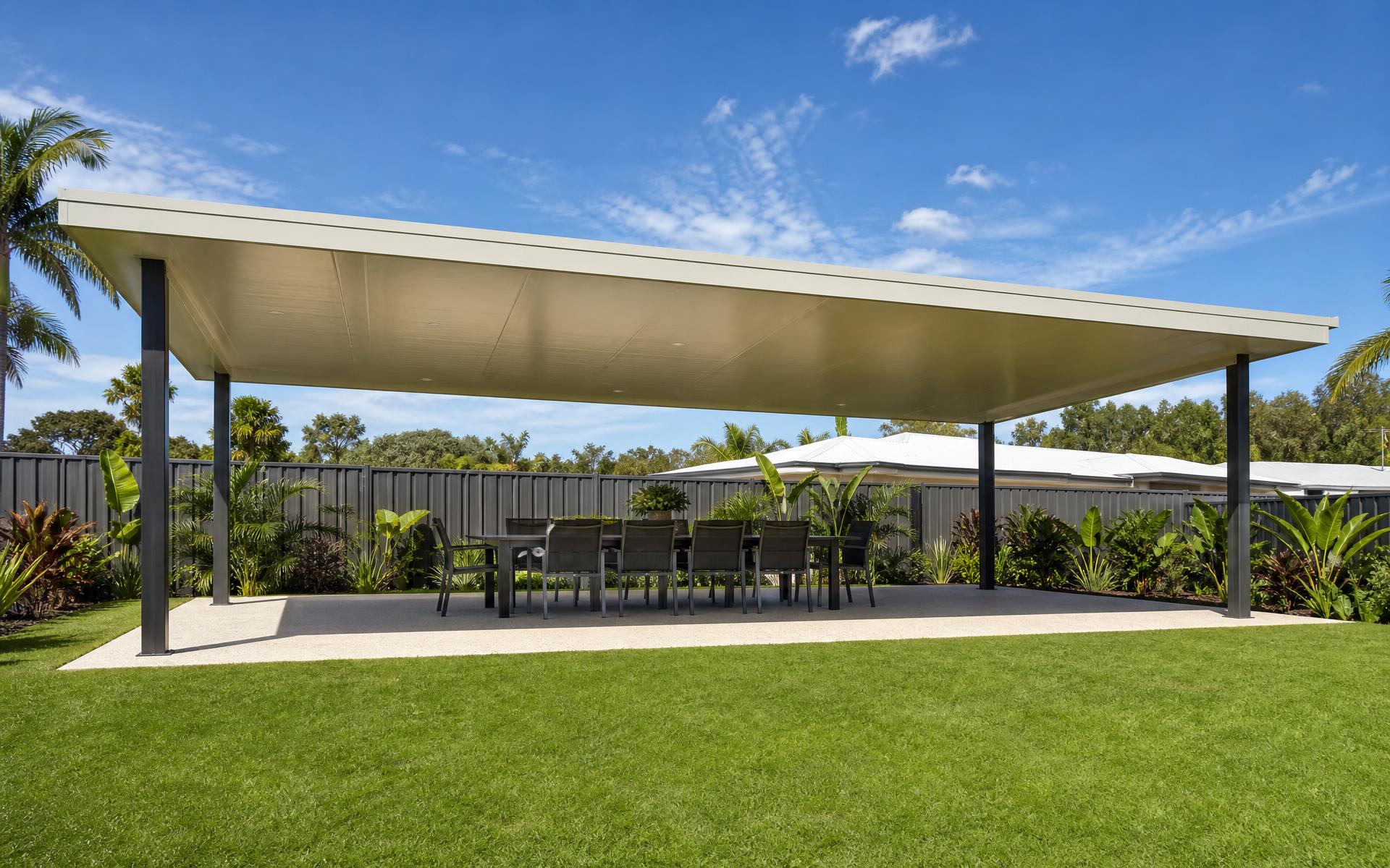 Freestanding insulated skillion patio 12m x 7m with cream COLORBOND roofing and outdoor dining area in a Queensland backyard